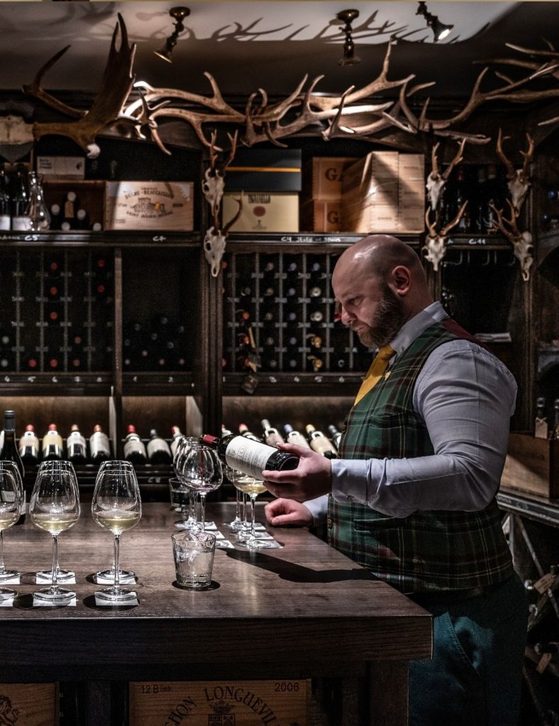 Sommelier preparing for a wine tasting in the cellar.