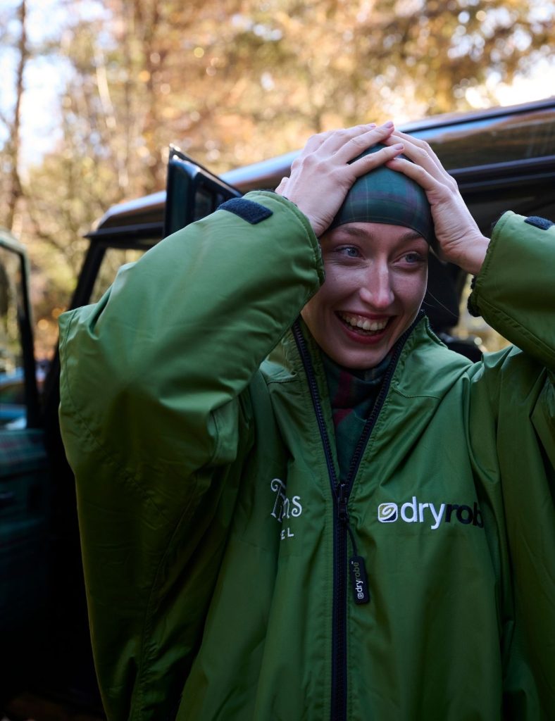 Guest putting on her swim cap wearing the Fife Arms dry robe.