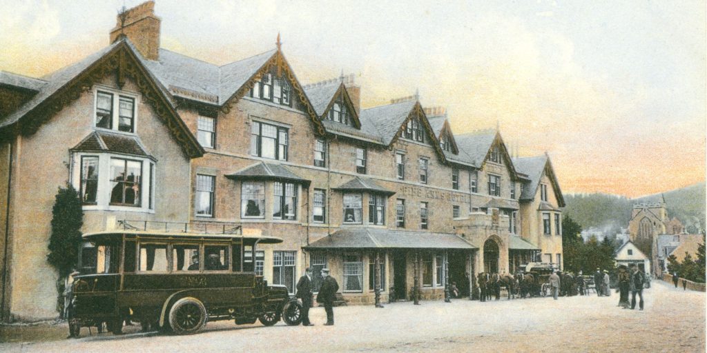 Exterior of the fife arms hotel with a traditional bus waiting outside the front